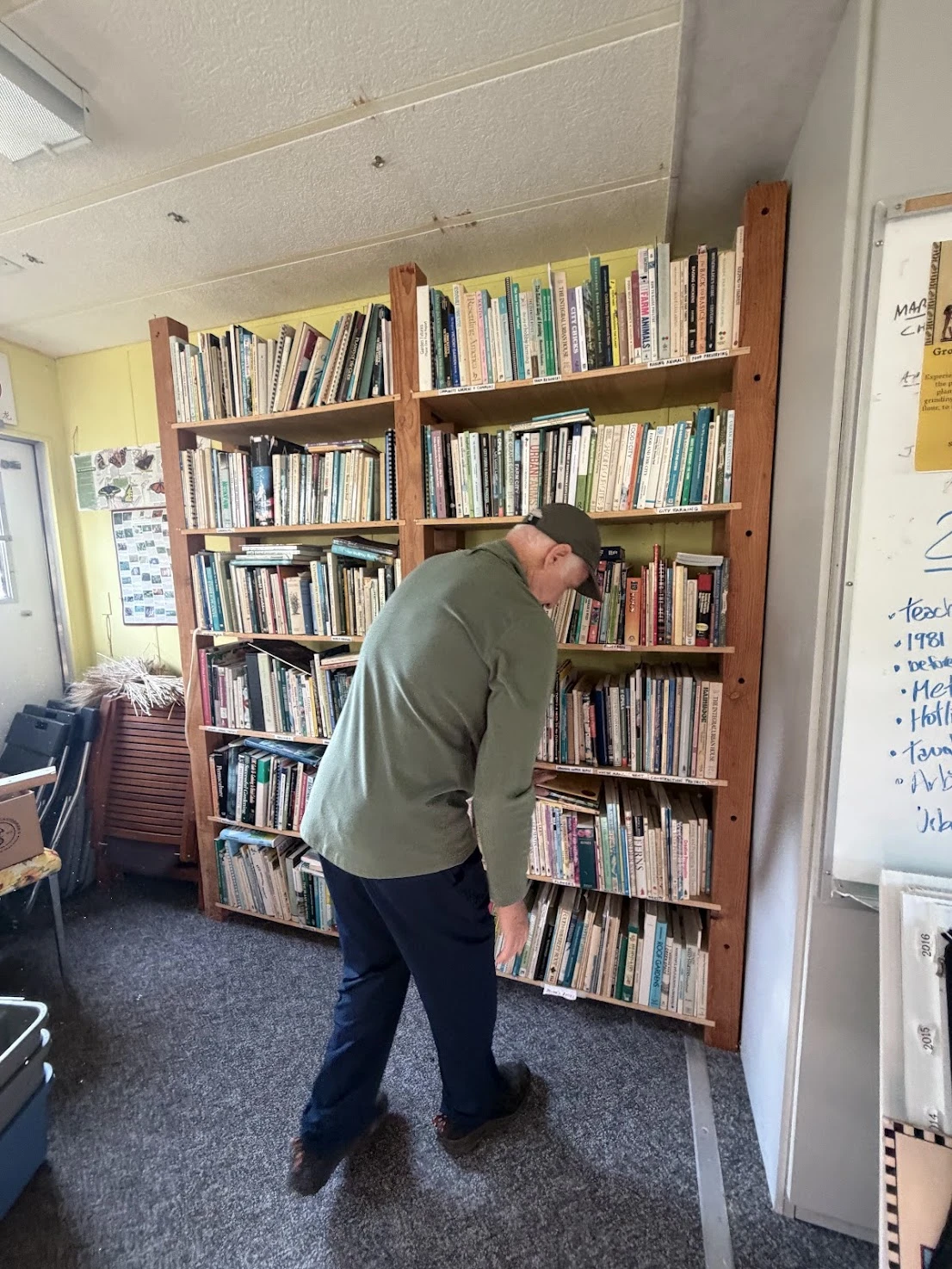 City Farmer's founder at the bookshelf of 280 rare urban agriculture books